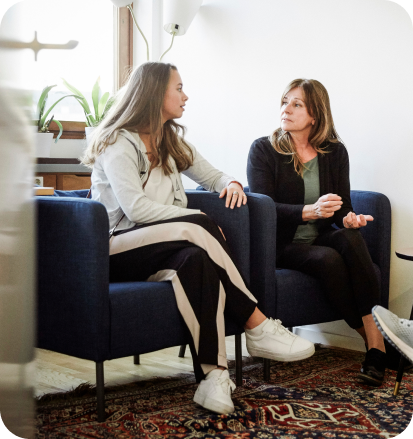 Two women share a personal moment in a professional setting.