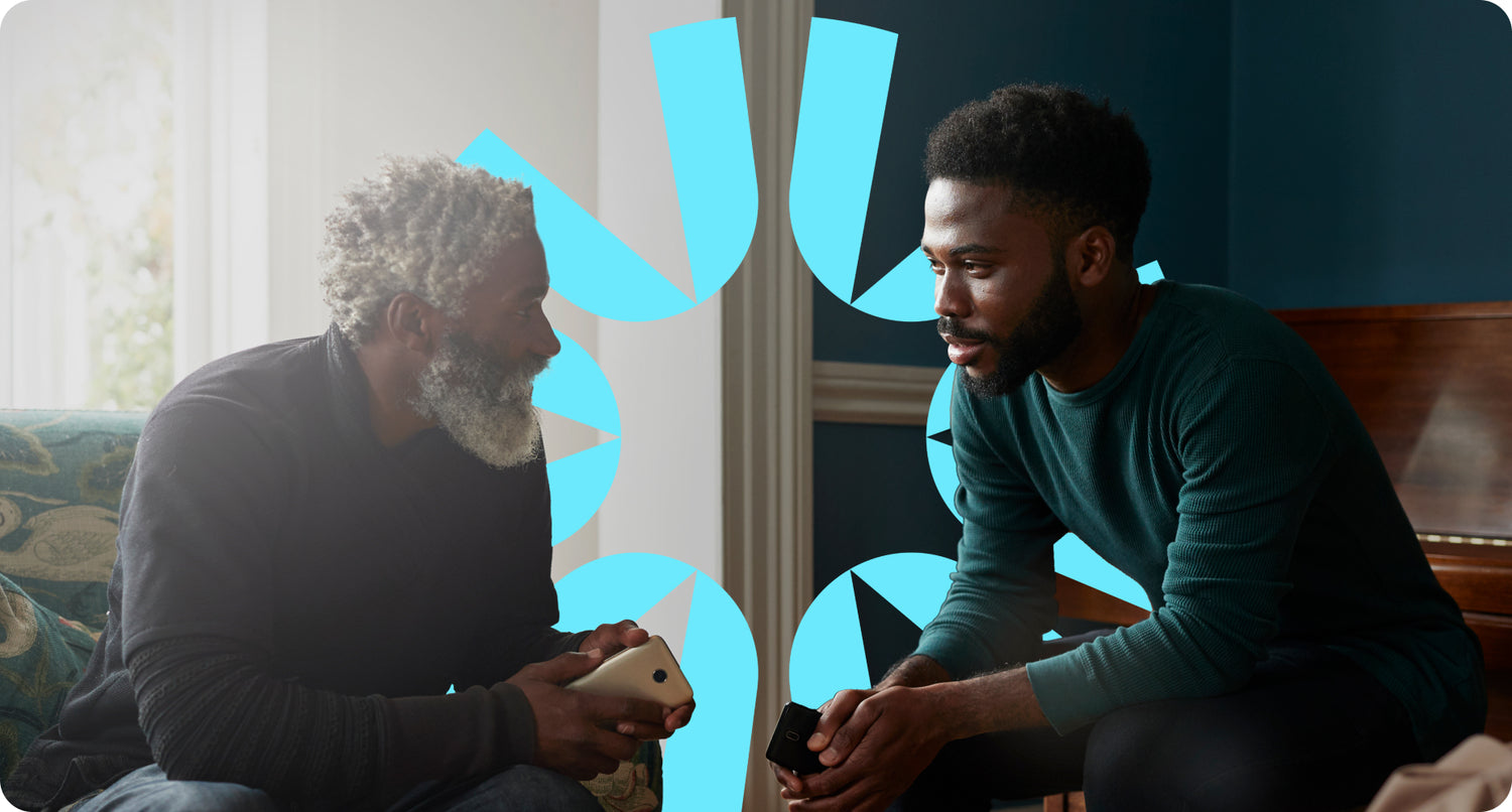 A father and son having a personal conversation in their home.