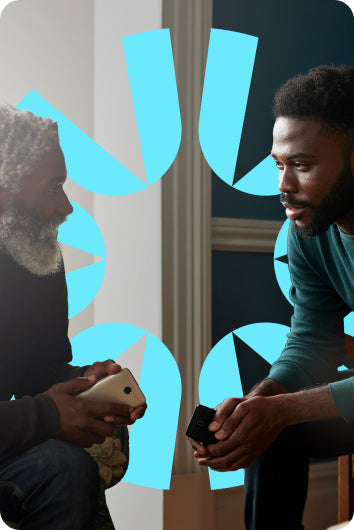 A father and son having a personal conversation in their home.